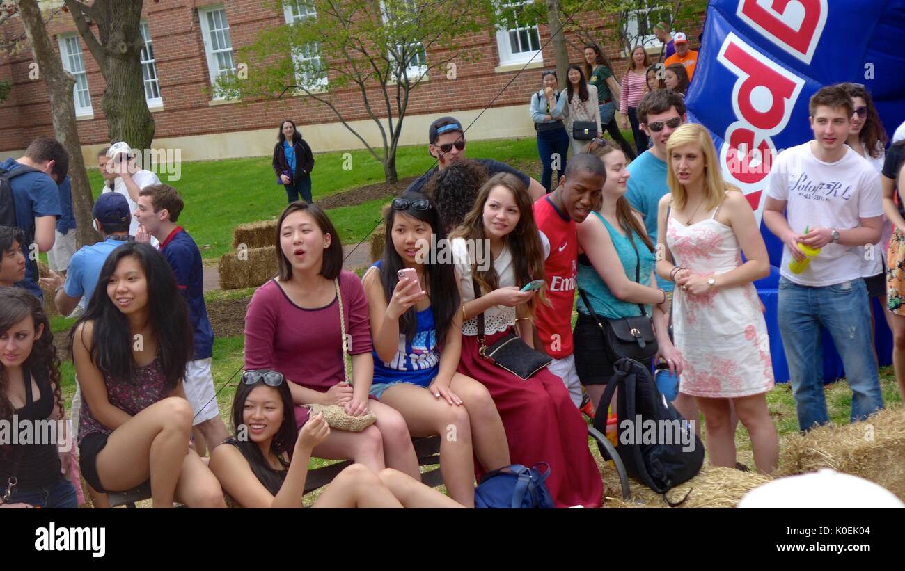College students watch their peers compete in the Red Bull chariot race during Spring Fair, an annual festival with music, food, shopping, and more that takes place every spring on the Homewood campus of the Johns Hopkins University in Baltimore, Maryland. 2014. Courtesy Eric Chen. Stock Photo