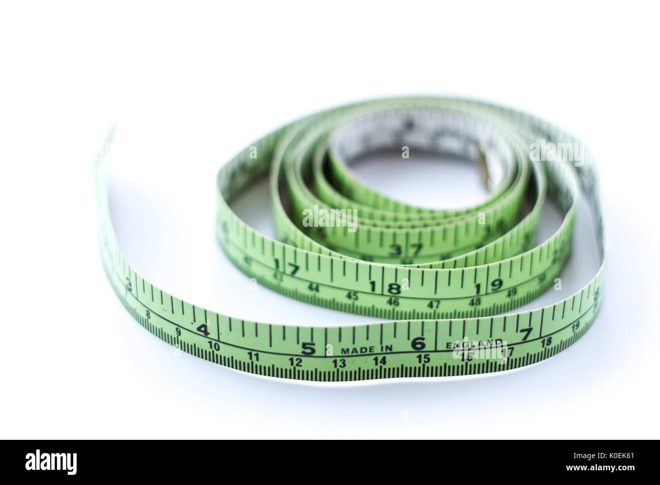 Green tape measure, with 'made in england' written on the front Stock Photo