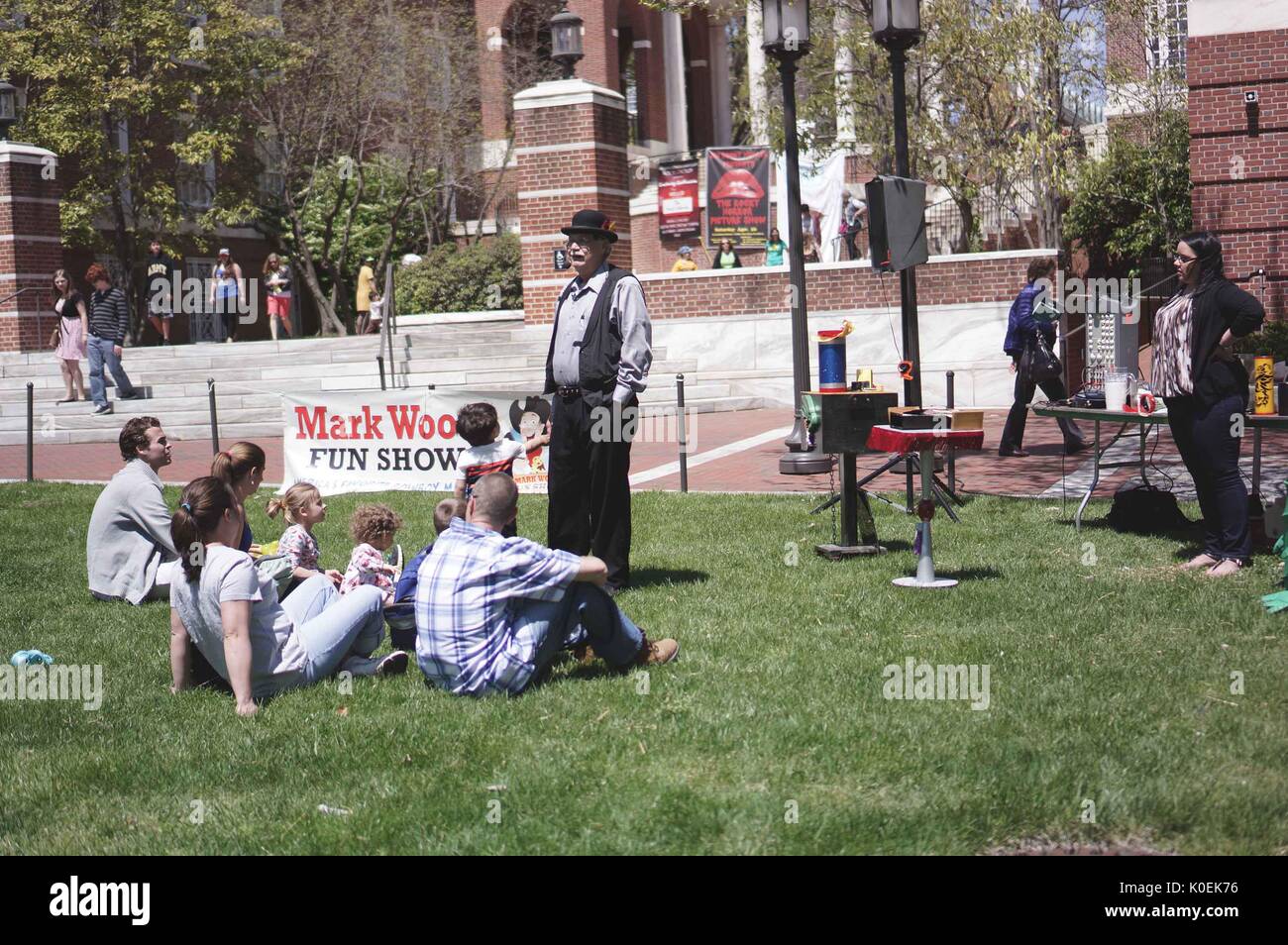 A performer gives a show to families with young children during Spring Fair, an annual festival with music, food, shopping, and more that takes place every spring on the Homewood campus of the Johns Hopkins University in Baltimore, Maryland. 2014. Courtesy Eric Chen. Stock Photo