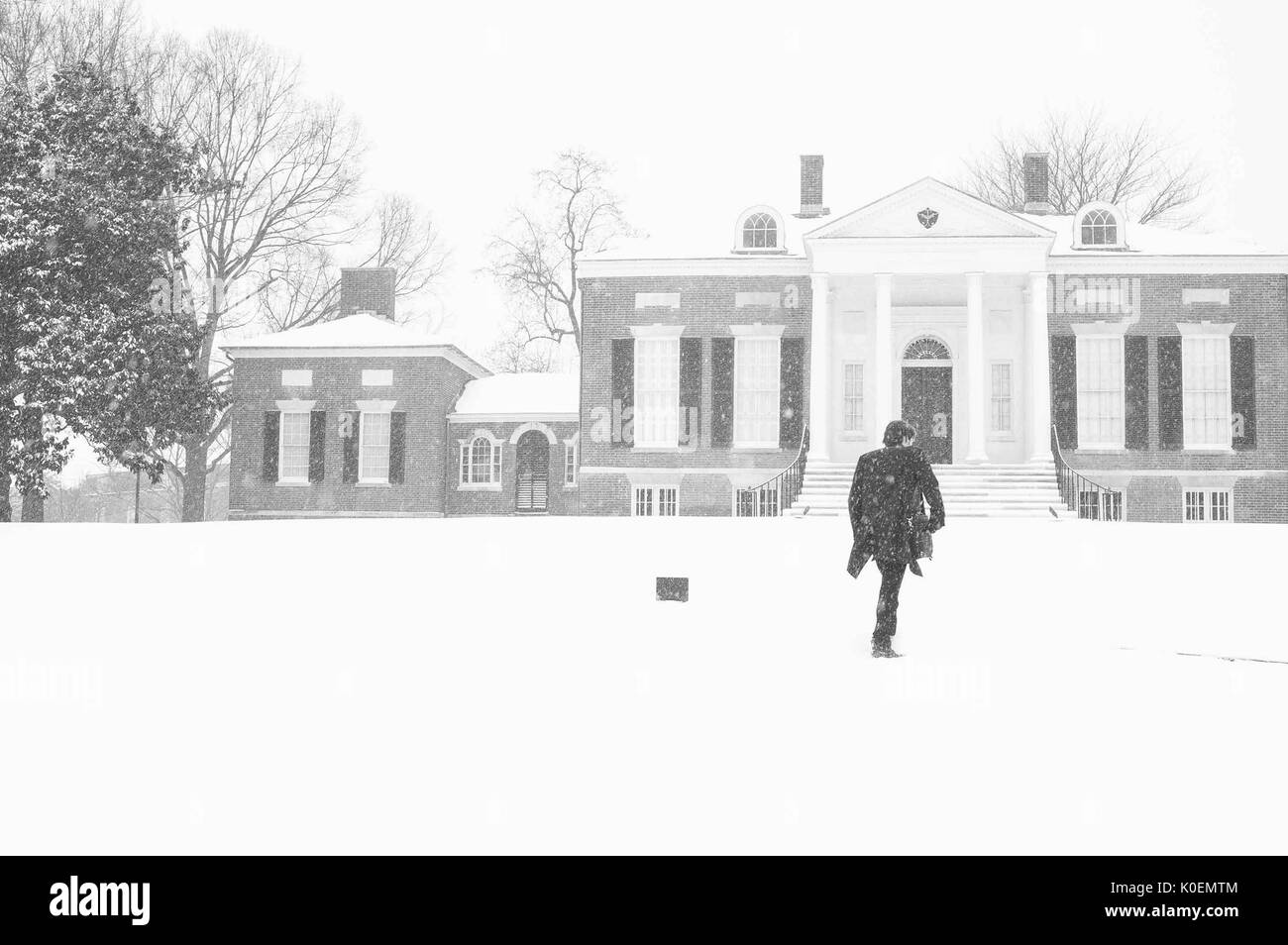 A man walks up to the Homewood Museum, whose collections include fine and decorative arts reminiscent of early-19th-century Baltimore life, on the snow-covered Homewood campus of the Johns Hopkins University in Baltimore, Maryland, 1996. Courtesy Eric Chen. Stock Photo