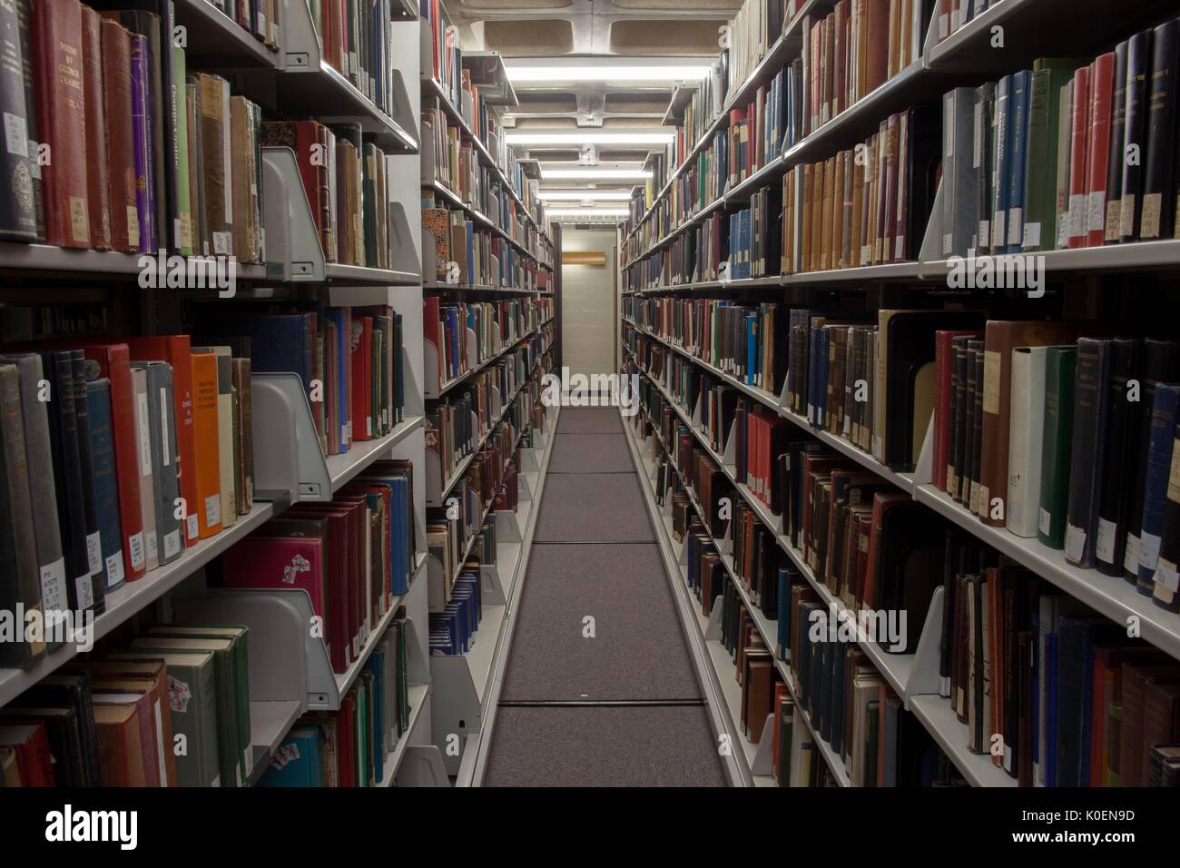 Shelves full of books on C-level, the lowest floor of the Milton S. Eisenhower Library on the Homewood campus of the Johns Hopkins University in Baltimore, Maryland, 2014. Courtesy Eric Chen. Stock Photo
