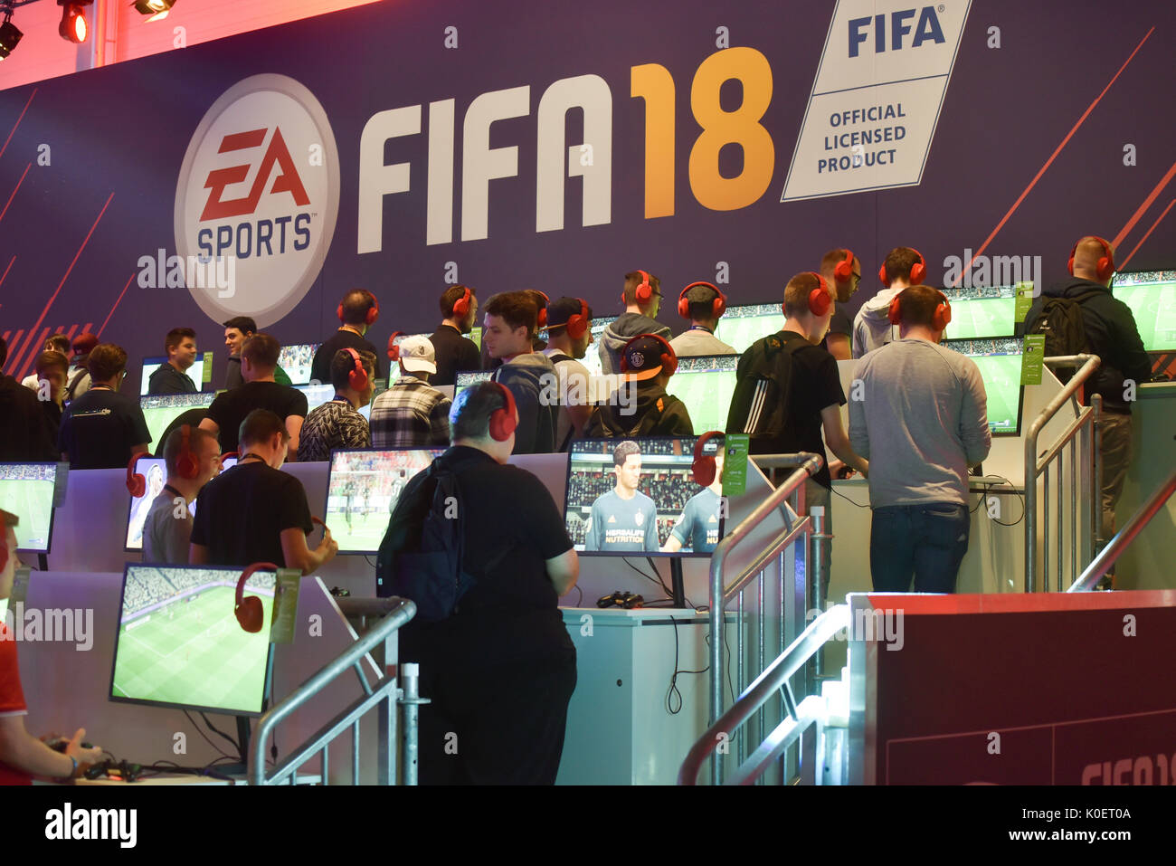 Cologne, Germany. 22nd Aug, 2017. Germany, Cologne, August 22, 2017, Gamescom: Players at the booth of EA Sports mit FIFA 18. Credit: Juergen Schwarz/Alamy Live News Stock Photo