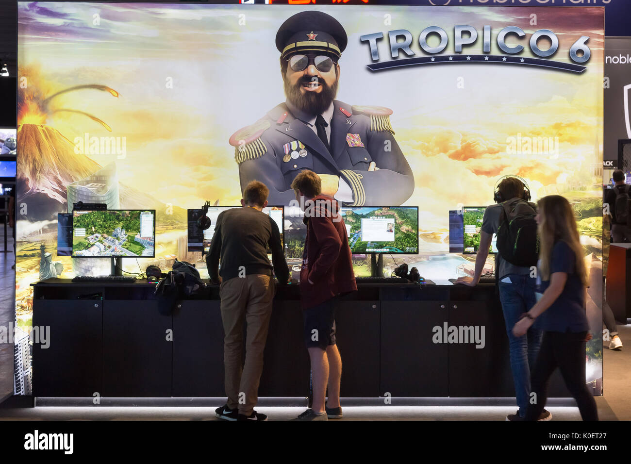 Cologne, Germany. 22nd Aug, 2017. Germany, Cologne, August 22, 2017, Gamescom: Players at booth of Tropico 6. Credit: Juergen Schwarz/Alamy Live News Stock Photo