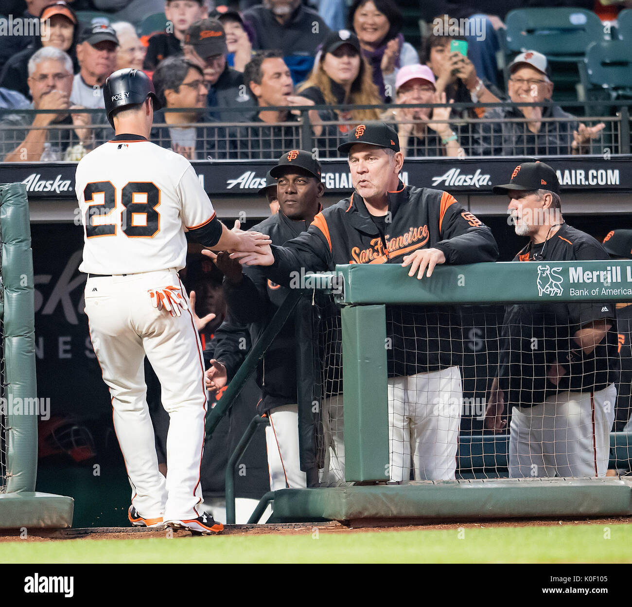 San Francisco, USA. 22nd Aug, 2017. San Francisco Giants catcher Buster Posey (28) is greeted in the dugout after scoring the Giant's first run, during a MLB game between the Milwaukee Brewers and the San Francisco Giants at AT&T Park in San Francisco, California. Credit: Cal Sport Media/Alamy Live News Stock Photo