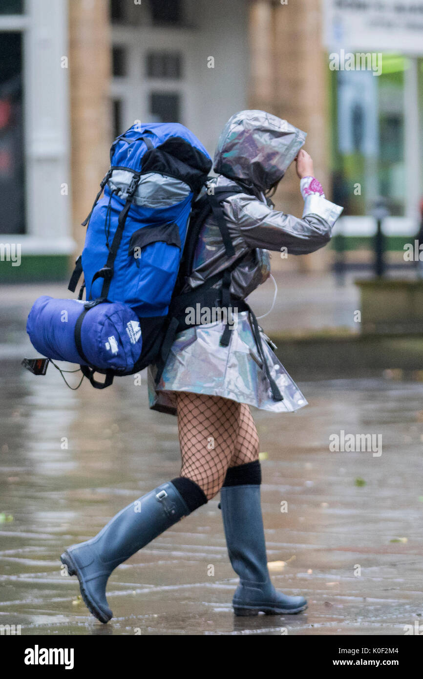Weather Stocking Woman with heavy haversack, wearing a short skirt and net stockings ...