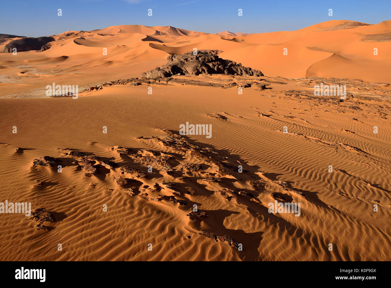 Sanddunes and rock towers at Moul Naga, Tadrart, Tassili n'Ajjer National Park, Sahara desert, Algeria Stock Photo