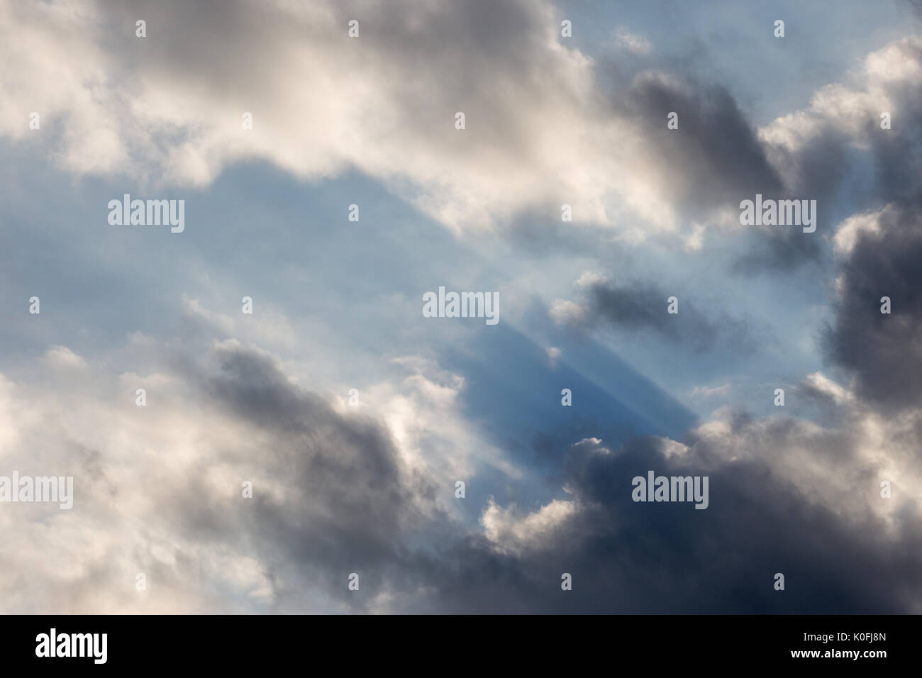 A close view of clouds with sun rays coming out through them Stock Photo