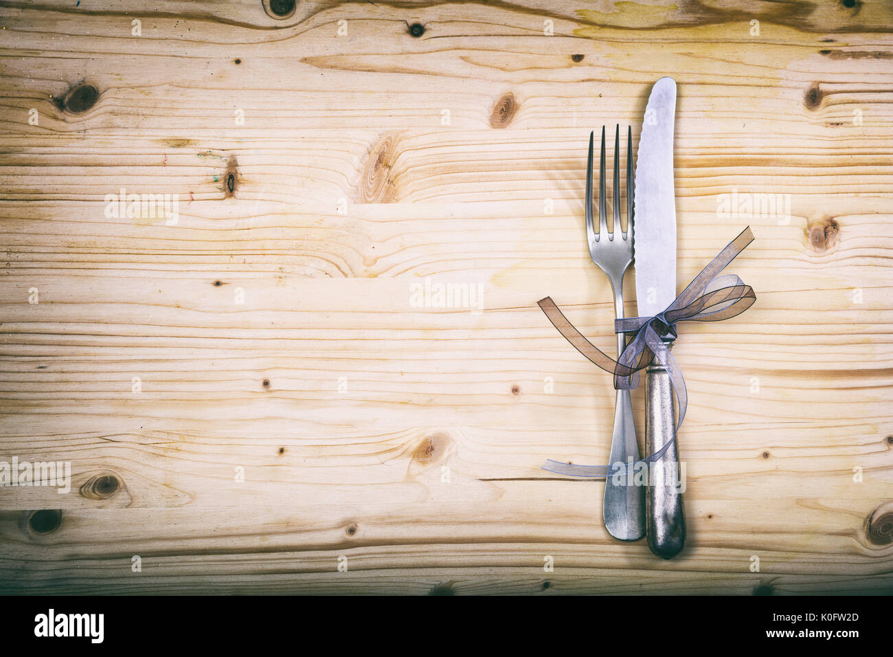 Table setting with fork and knife on wooden background Stock Photo - Alamy