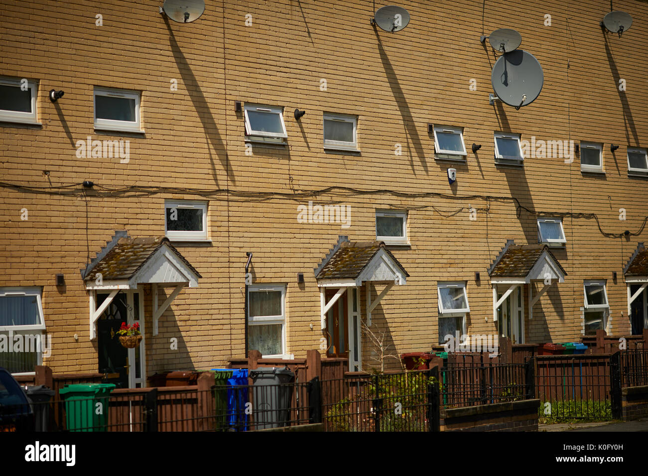 Yellow brick modern houses with small windows in Moss Side South