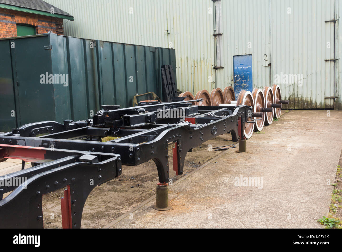 Railway carriage bogies and wheels undergoing restoration work at workshops at Rothley station on the Great Central Railway preserved steam line. Stock Photo