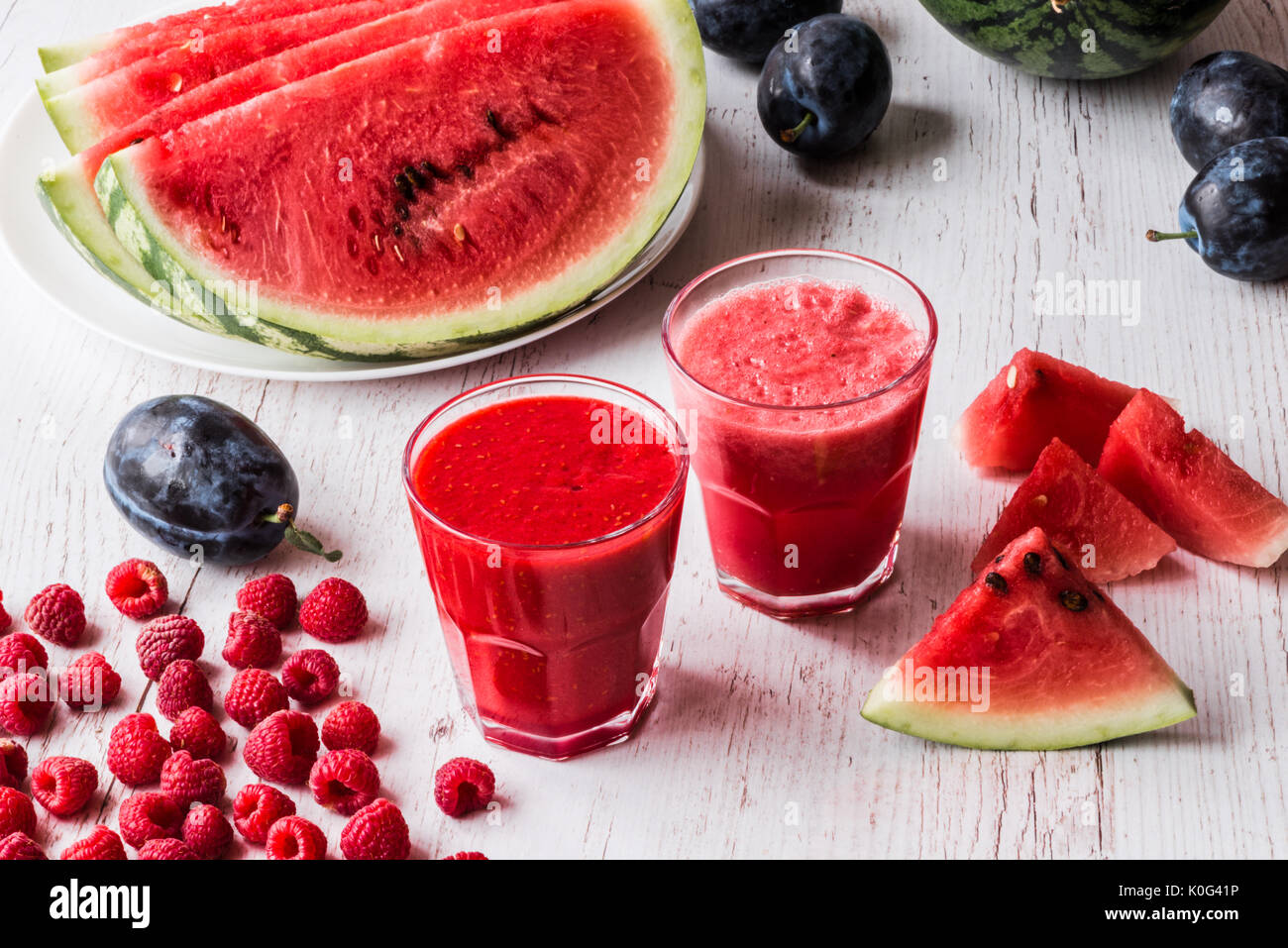 healthy drinks. watermelon and raspberry smoothies on white wooden ...