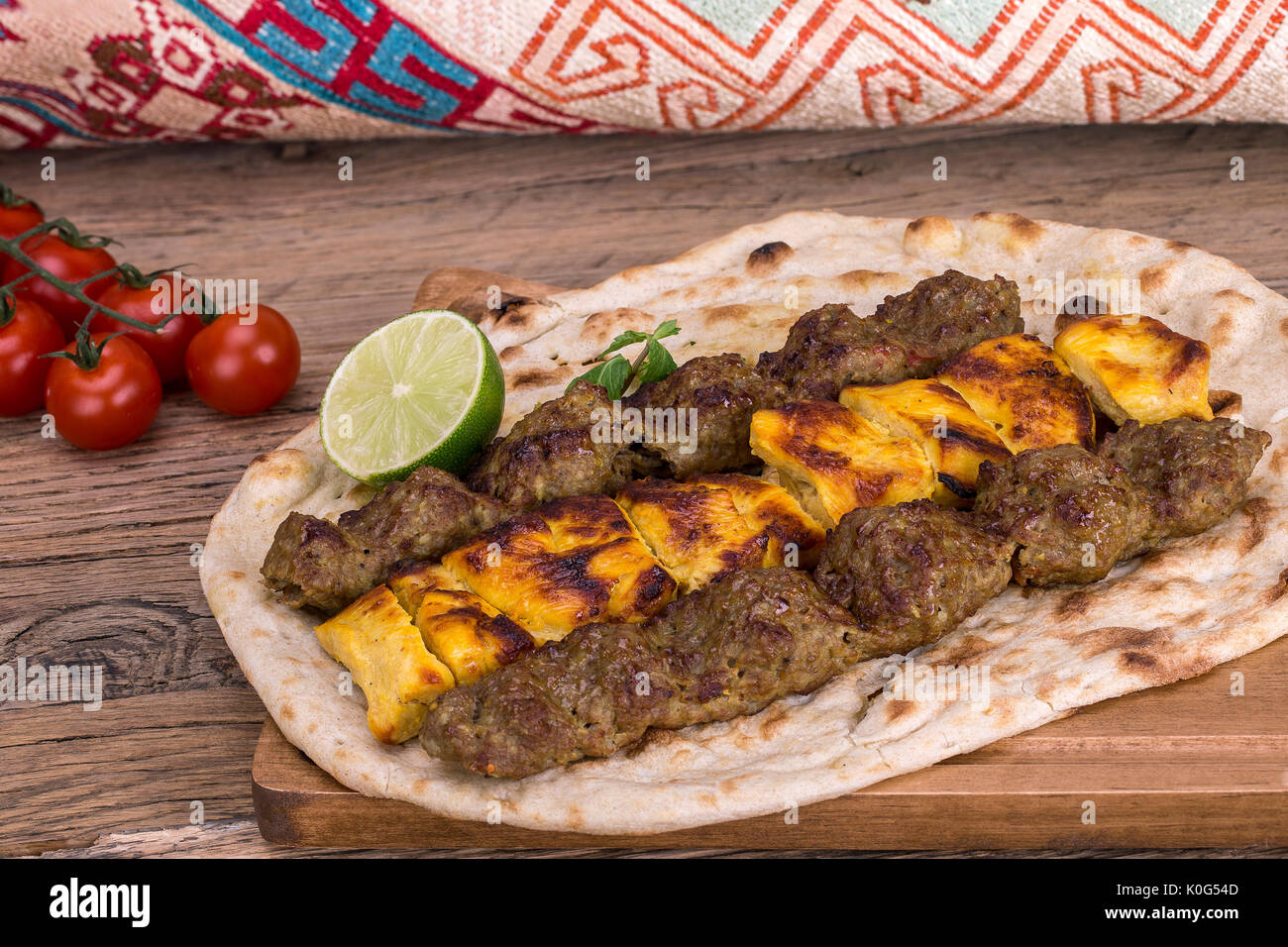 Traditional Persian Dish of Kebab and rice on wooden Table Stock Photo