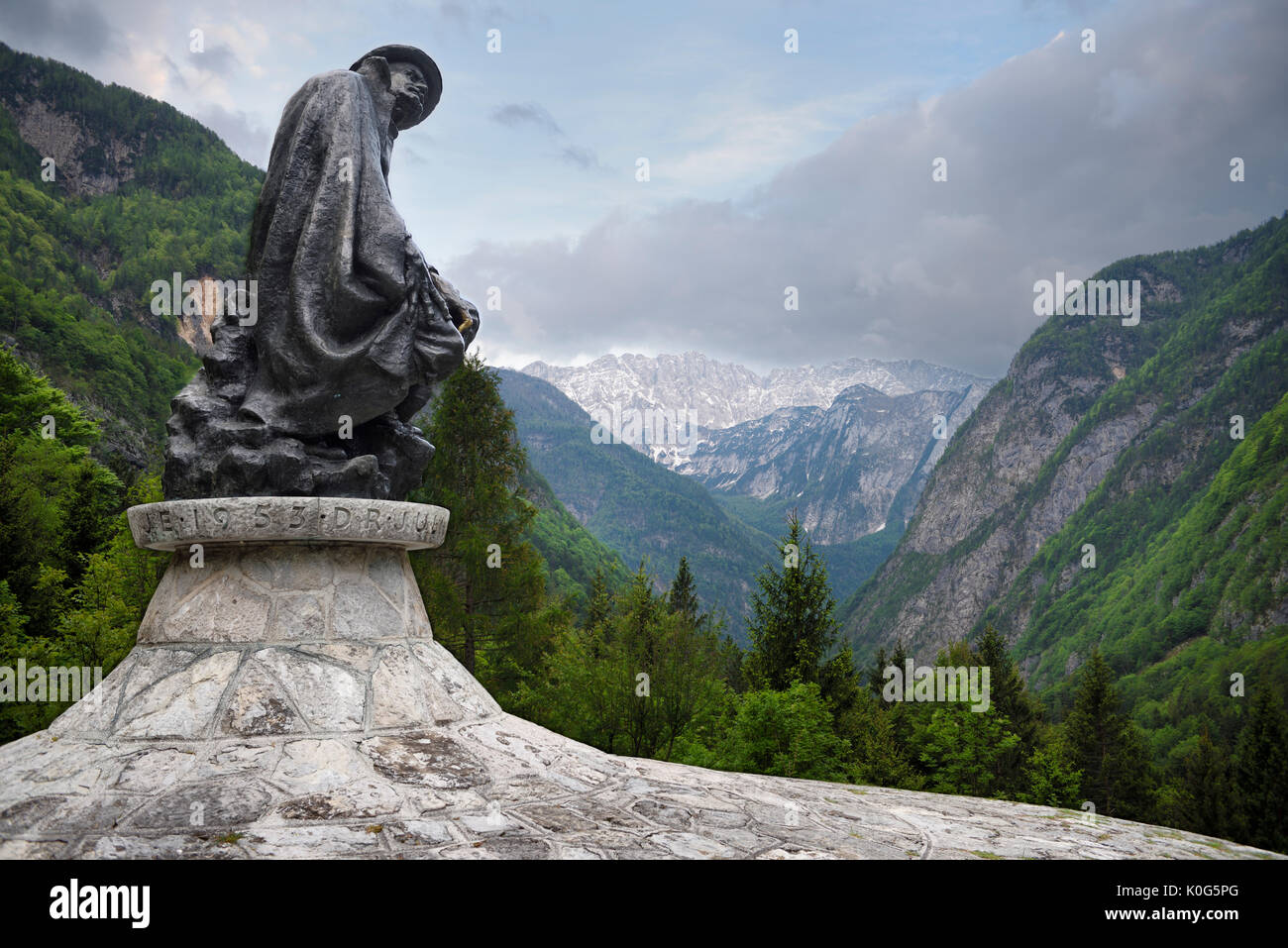 Sculpture of mountaineer Dr Julius Kugy in Trenta Valley with Veliko Spicje peak in Triglav National Park Julian Alps Slovenia Stock Photo