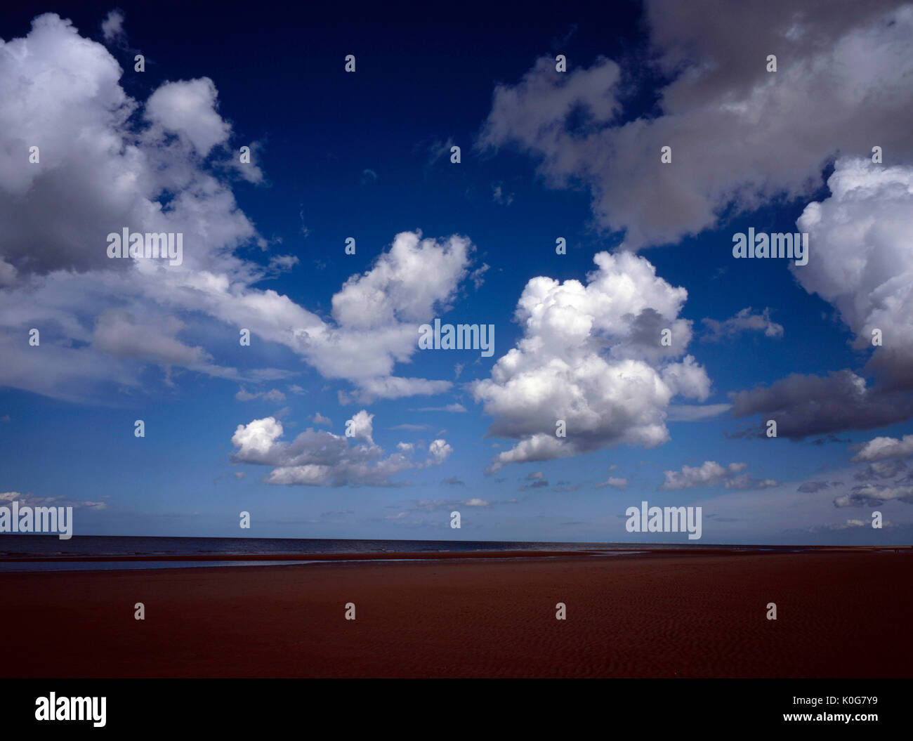 Cloud passing over the sandy beach at Holkham on a late summer early autumn day North Norfolk England Stock Photo