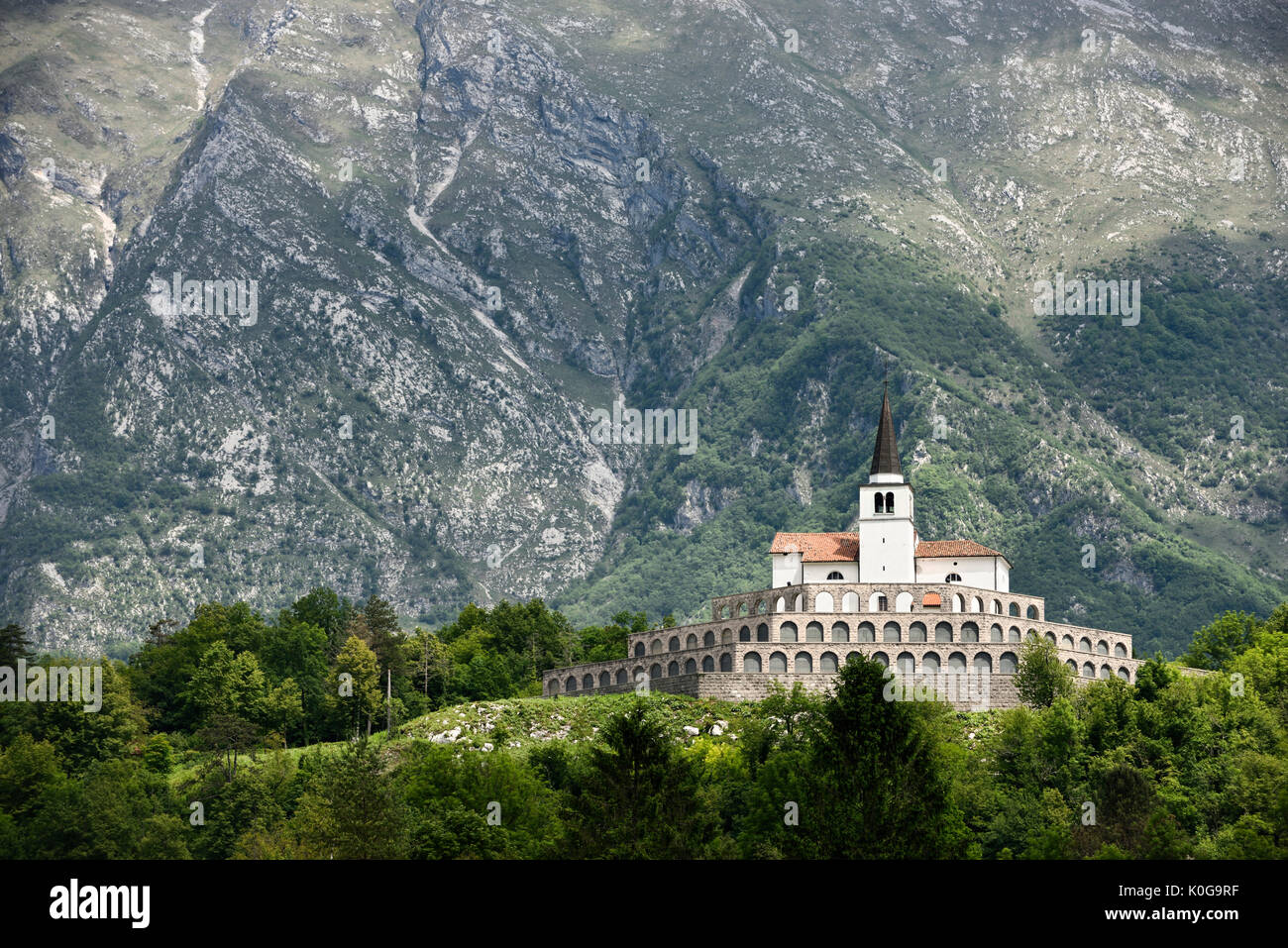 St Anton church at First World War memorial cemetery ossuary of fallen Italian soldiers at Kobarid Slovenia with Krn mountain backdrop Stock Photo