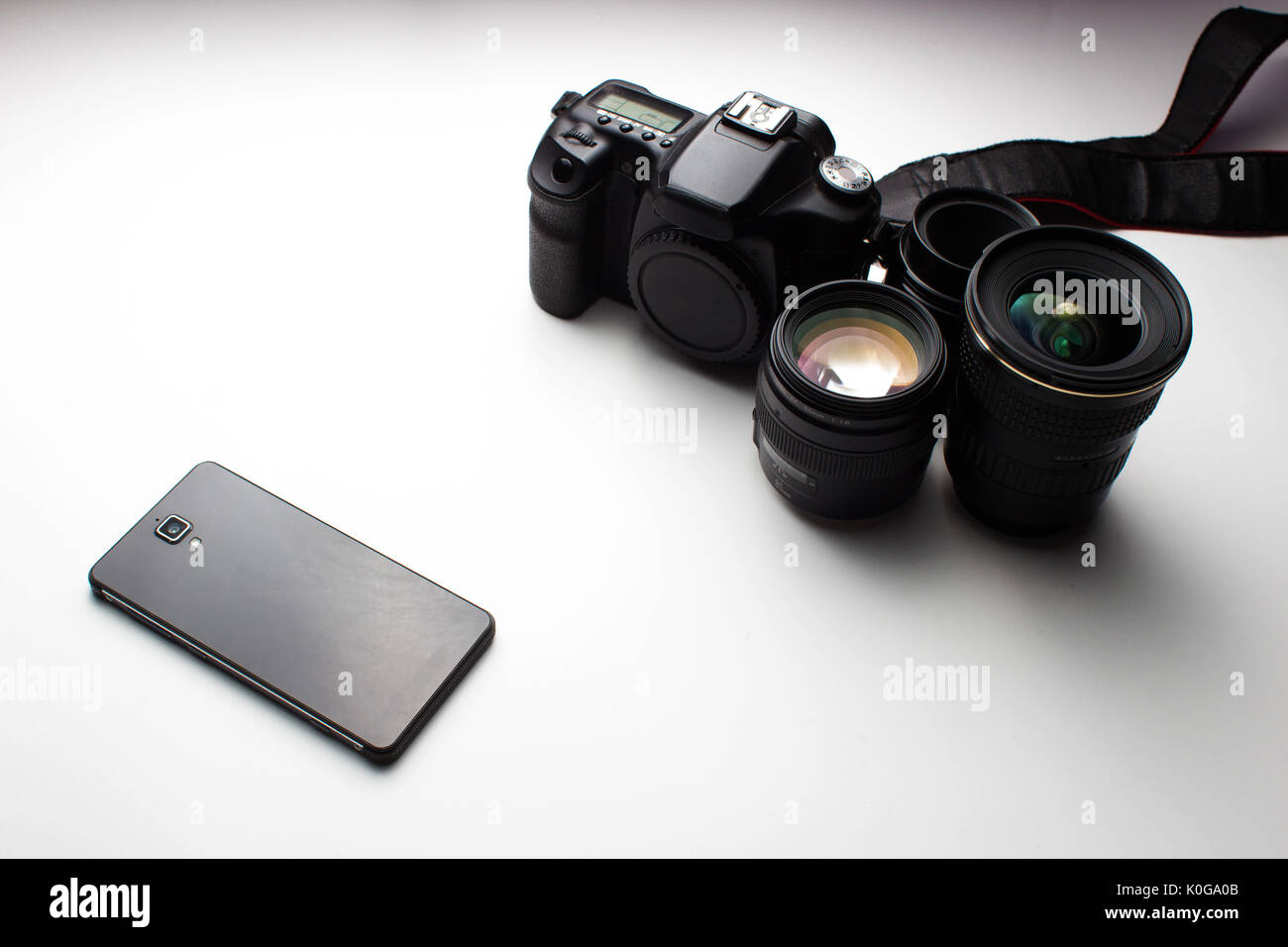 group of camera lenses and a mobile phone on a white background Stock Photo