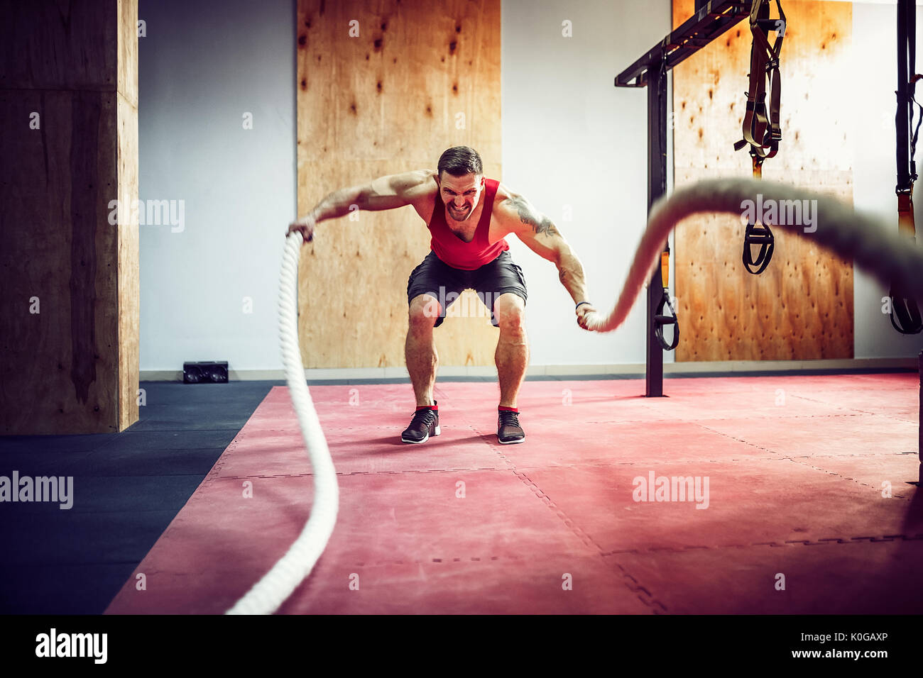 Men with rope in functional training fitness Stock Photo - Alamy