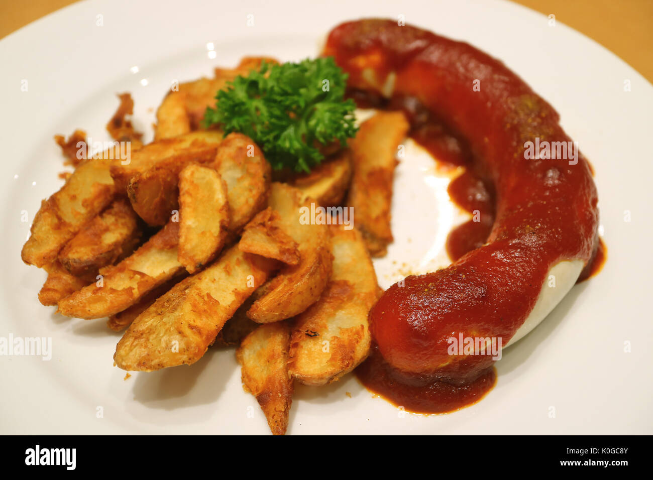 German Weisswurst Sausage with Curry Ketchup and Fried Potatoes Stock Photo