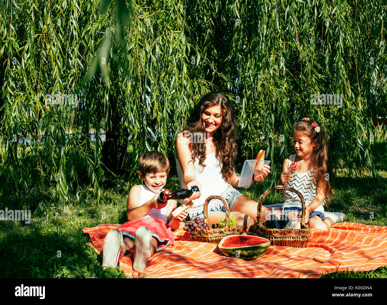 cute happy family on picnic laying on green grass mother and kid Stock ...