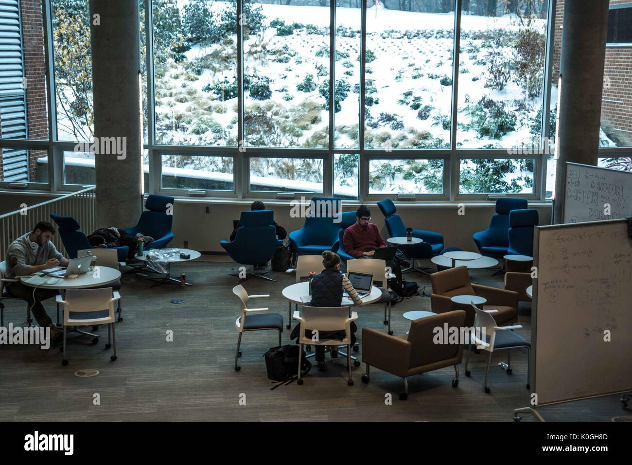 Students study in the Brody Learning commons, an interactive/collaborative study space and library, while it is a snow day on the Homewood campus of the Johns Hopkins University in Baltimore, Maryland, 2014. Courtesy Eric Chen. Stock Photo