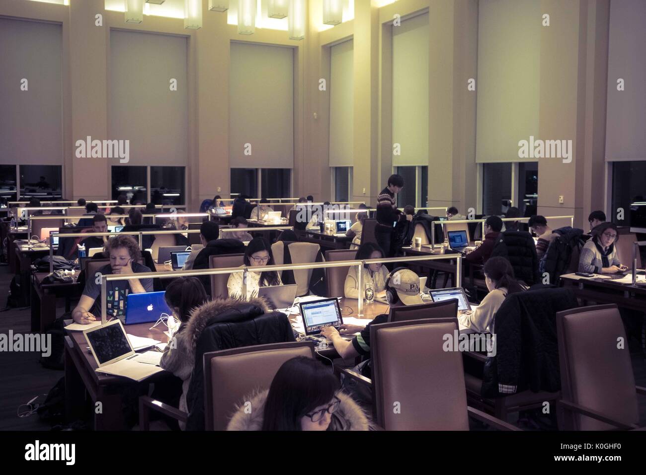 College students study at night in the reading room of the Brody Learning Commons, a study space and library on the Homewood campus of the Johns Hopkins University in Baltimore, Maryland, 2015. Courtesy Eric Chen. Stock Photo