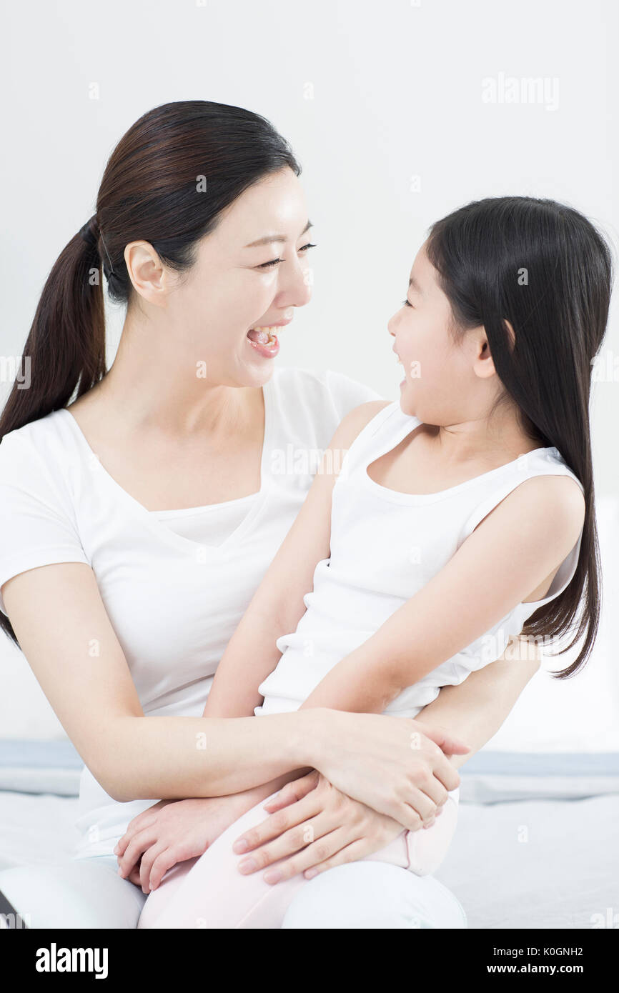 Smiling mother and daughter hugging Stock Photo