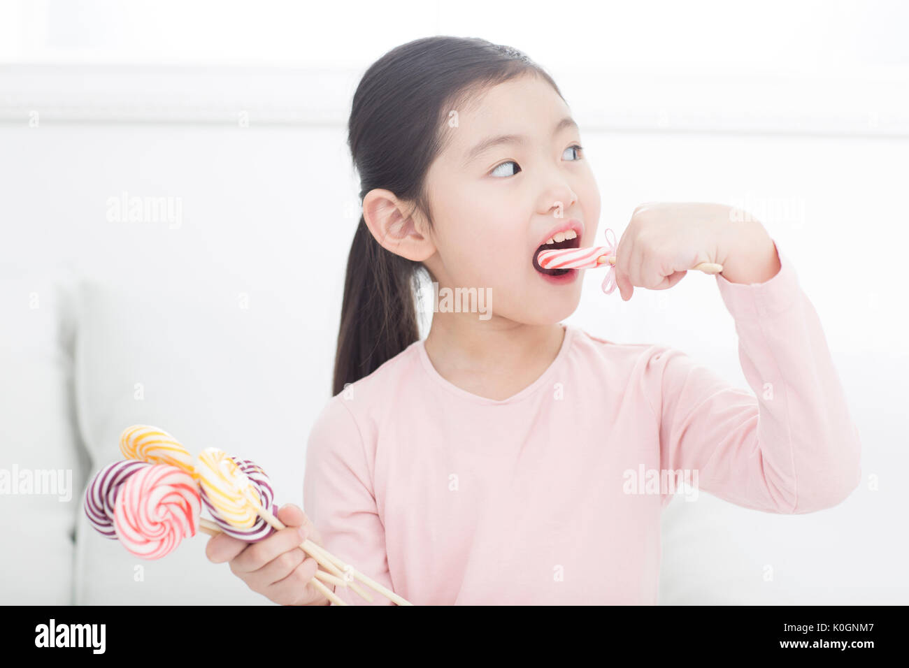 Portrait of girl eating lollipops Stock Photo