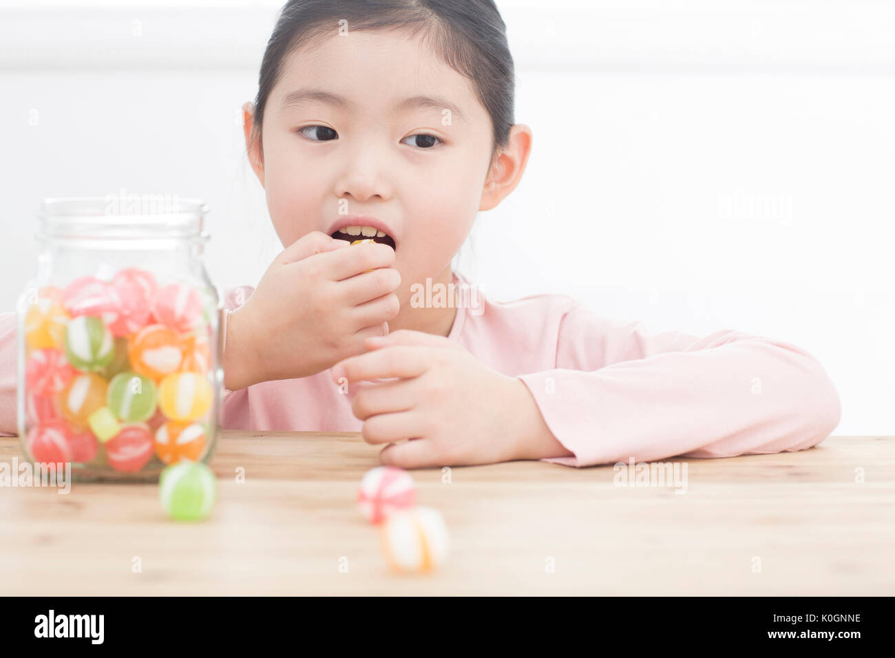 Portrait of smiling girl with candies Stock Photo