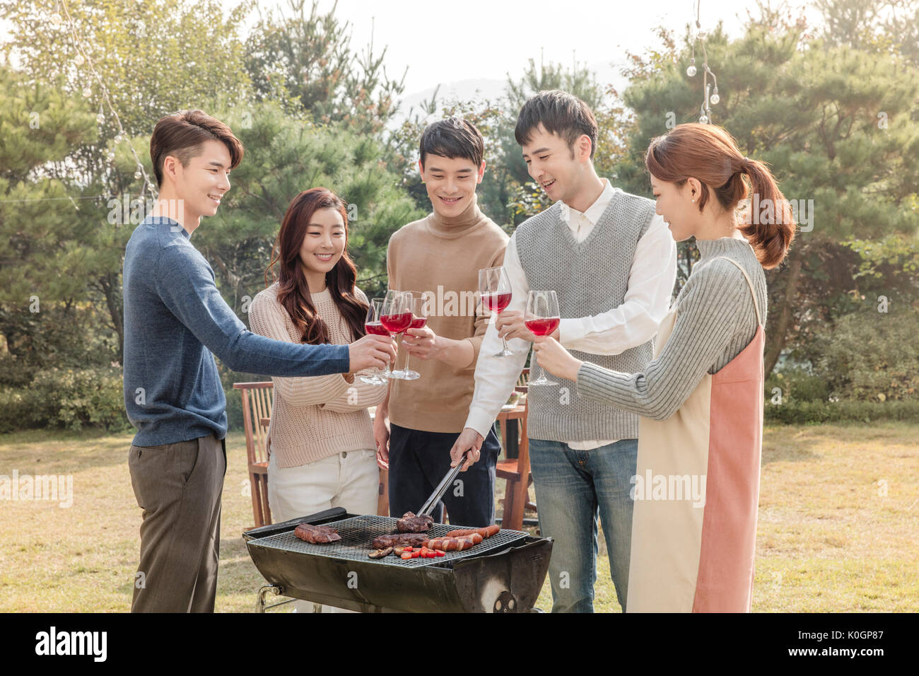 Young smiling friends having a barbecue party Stock Photo