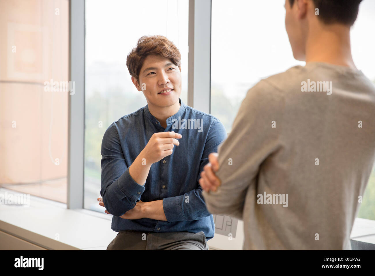 Two smiling businessmen having a meeting Stock Photo