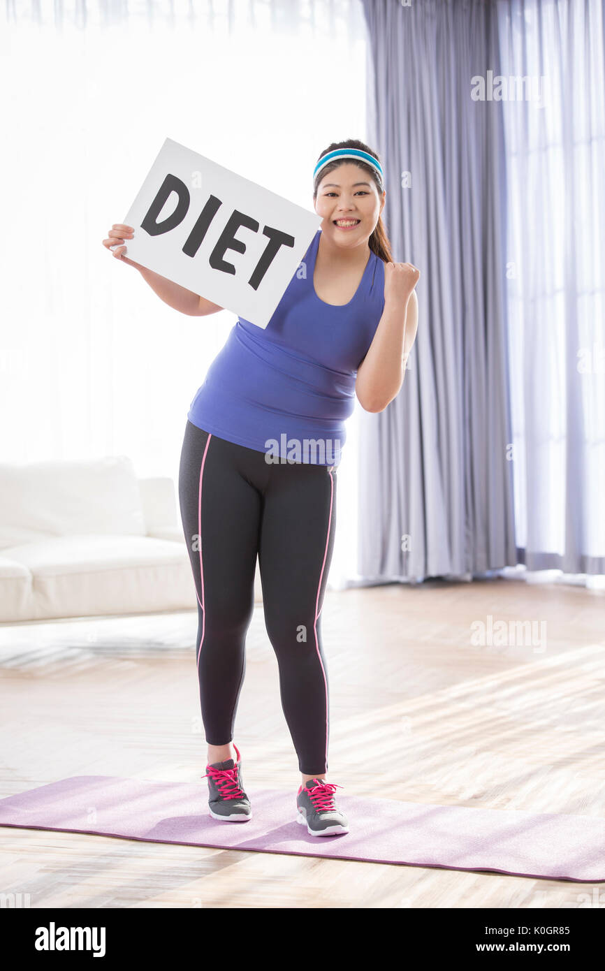 Young smiling fat woman deciding to go on a diet Stock Photo