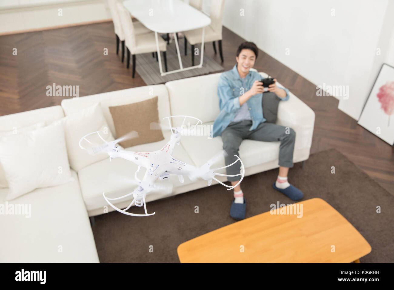 Smiling male kidult playing with drone Stock Photo