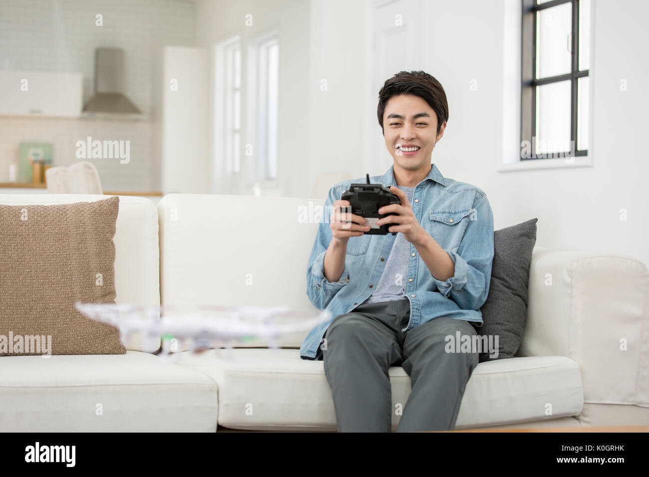 Smiling male kidult playing with drone Stock Photo
