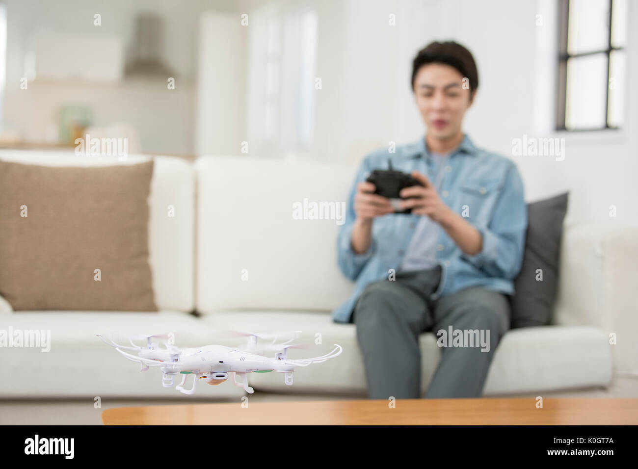Smiling male kidult playing with drone Stock Photo