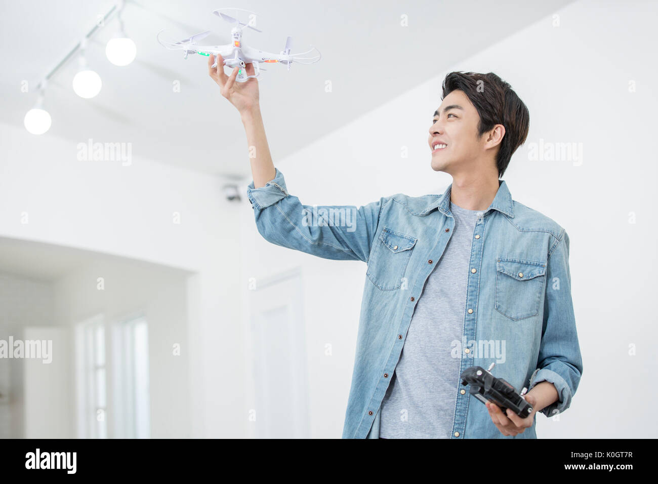 Smiling male kidult playing with drone Stock Photo