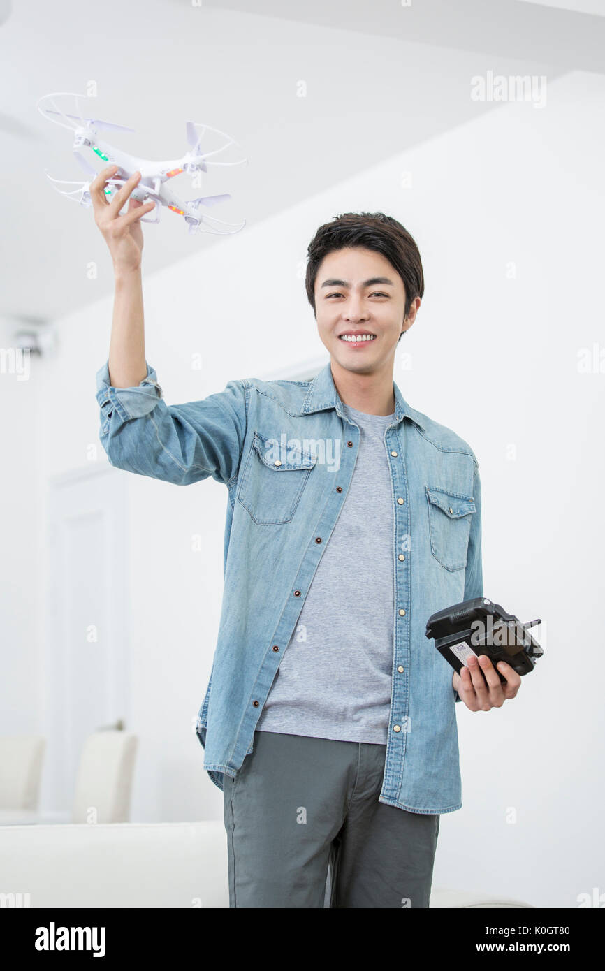 Smiling male kidult playing with drone Stock Photo