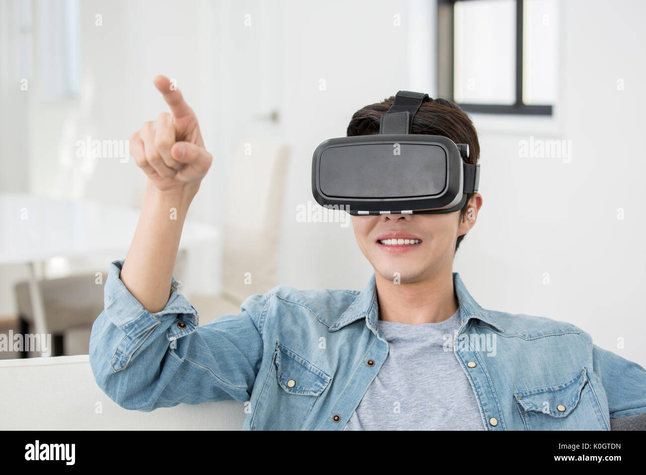 Portrait of smiling man enjoying virtual reality Stock Photo - Alamy