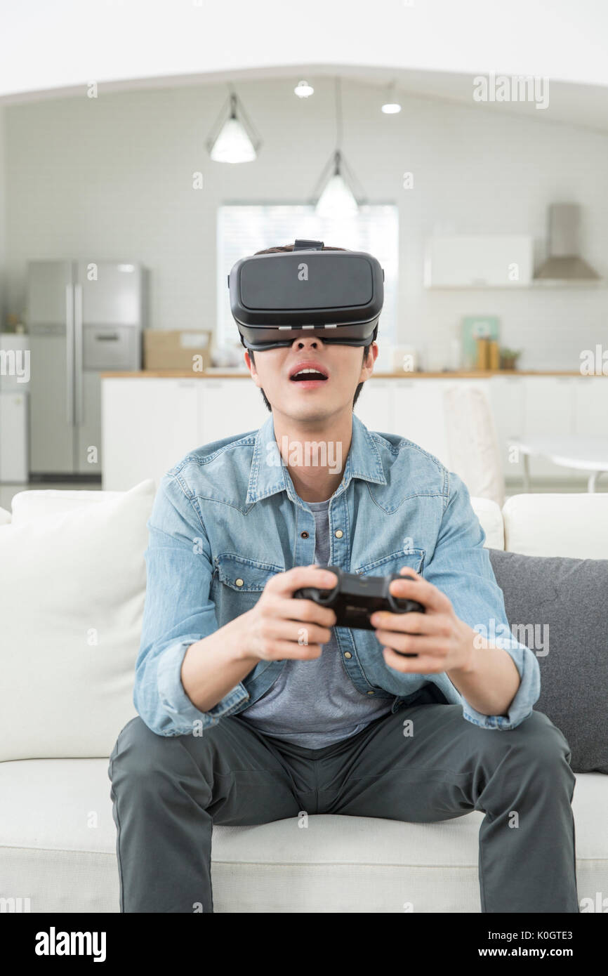 Man enjoying virtual reality game Stock Photo