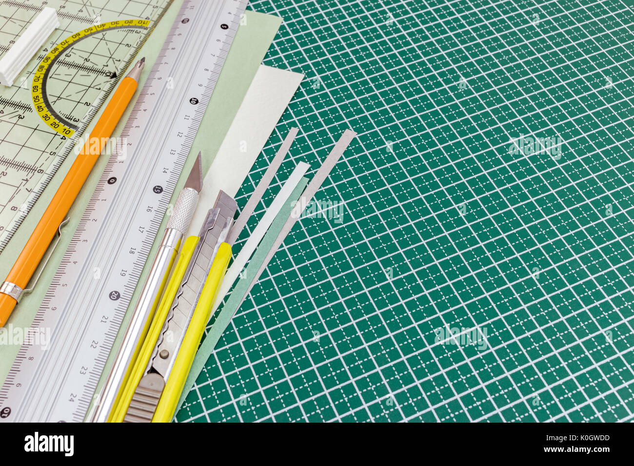cutting mat with utility knife, mechanical pencil, metal ruler and