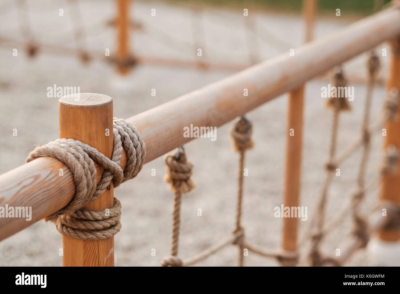 A wooden fence with rope at a playground Stock Photo