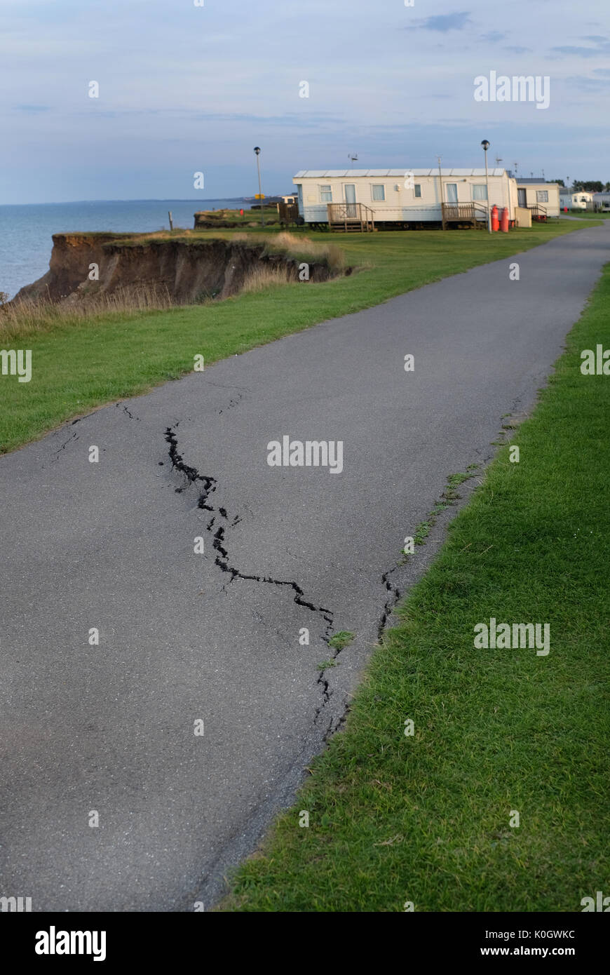 Road cracking on caravan park due to clay cliff erosion at coast Stock ...