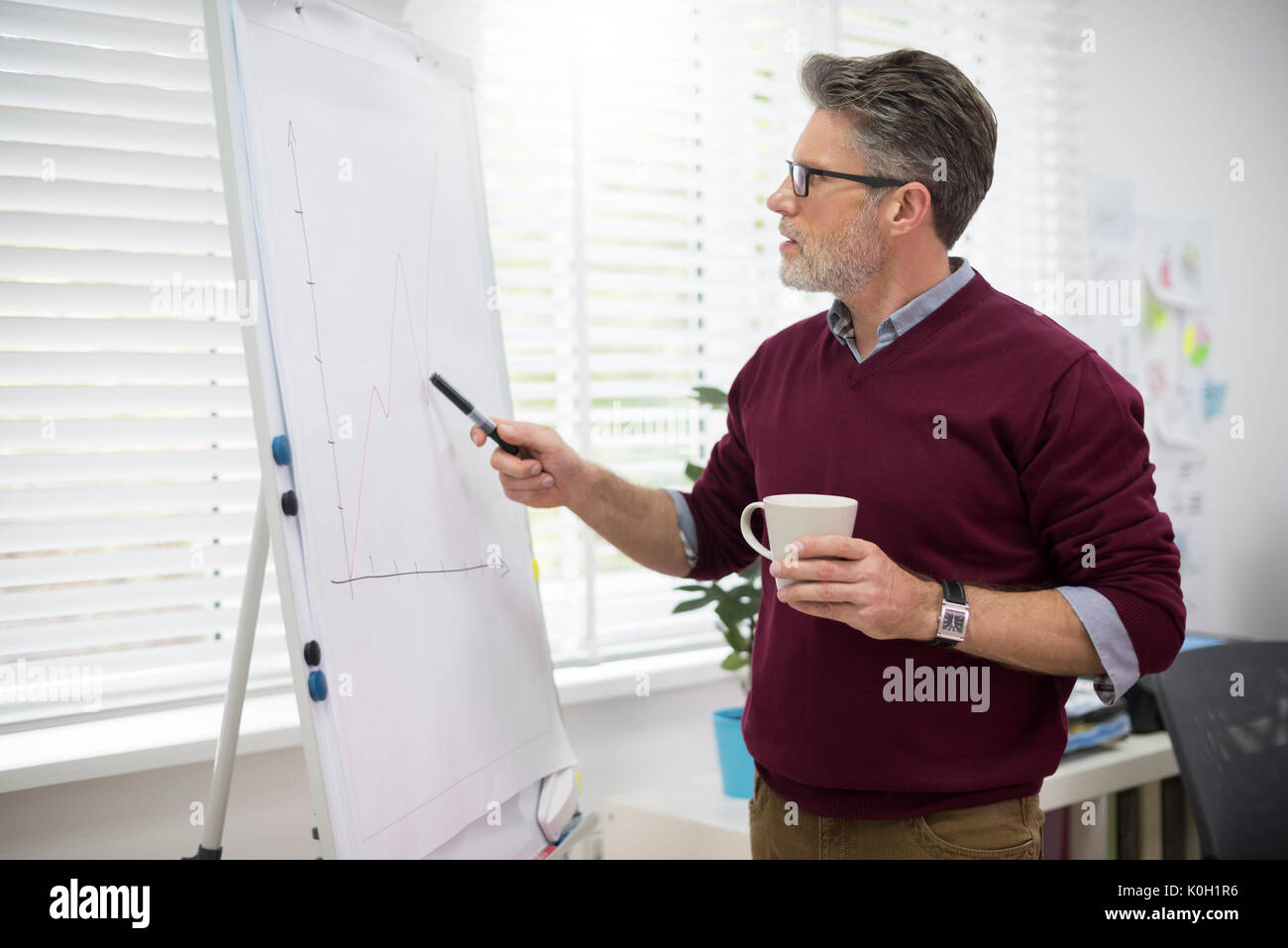 Hardworking man next to the white board Stock Photo