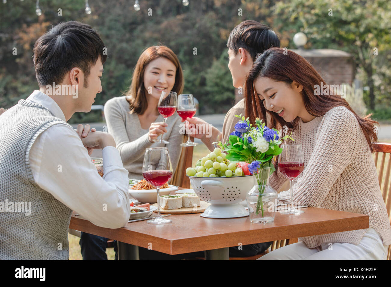 Young smiling people enjoying a party at garden Stock Photo
