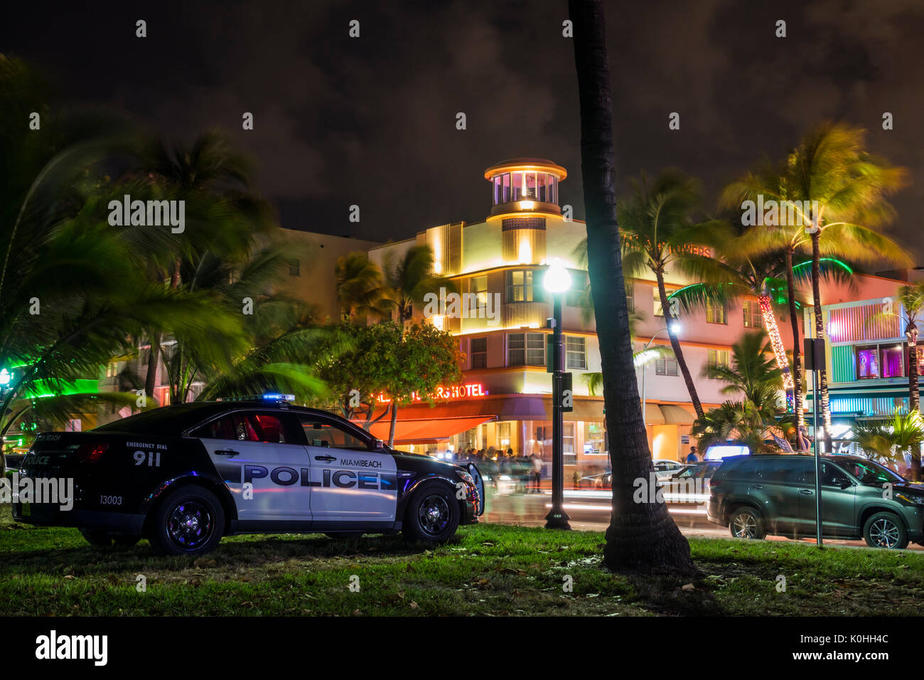 Miami Beach Florida,Ocean Drive,night evening Lummus Park,hotels,neon signs,lighting,palm trees,police car,Waldorf Towers,hotel,FL170430100 Stock Photo
