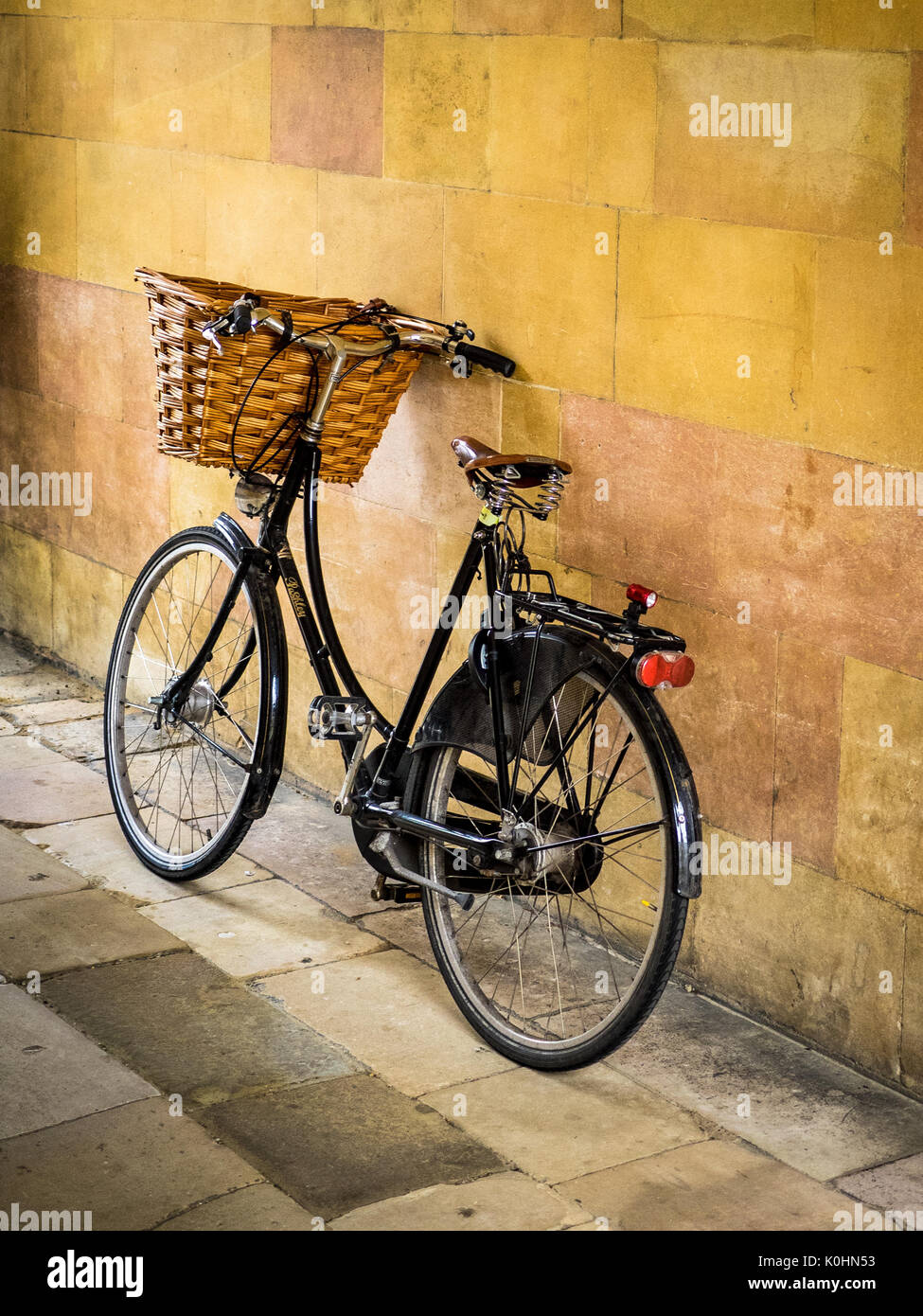 University Student Bike Cambridge - a traditional British Bike sits in a passage in Clare College, part of Cambridge University Stock Photo