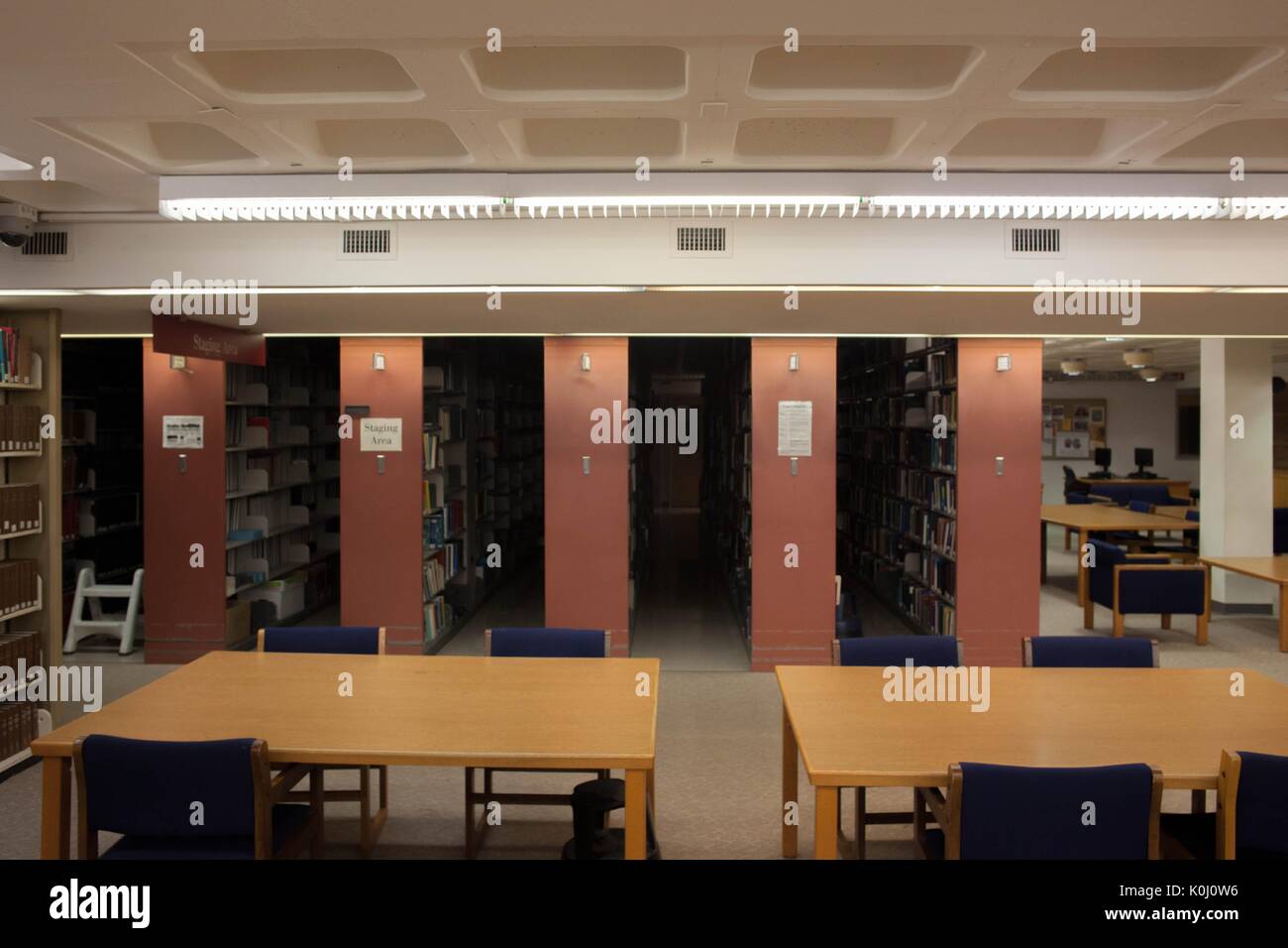 Two empty tables in the library with red stacks behind the tables, 2014. Courtesy Eric Chen. Stock Photo