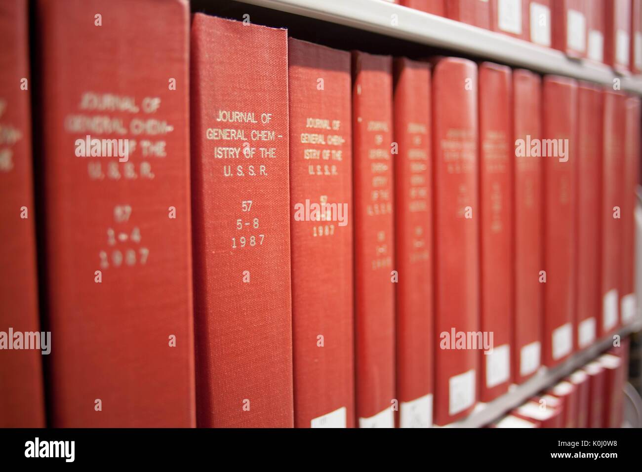 Photograph of red books on a shelf reading 'The Journal of General Chemistry of the USSR in volumes, 2014. Courtesy Eric Chen. Stock Photo