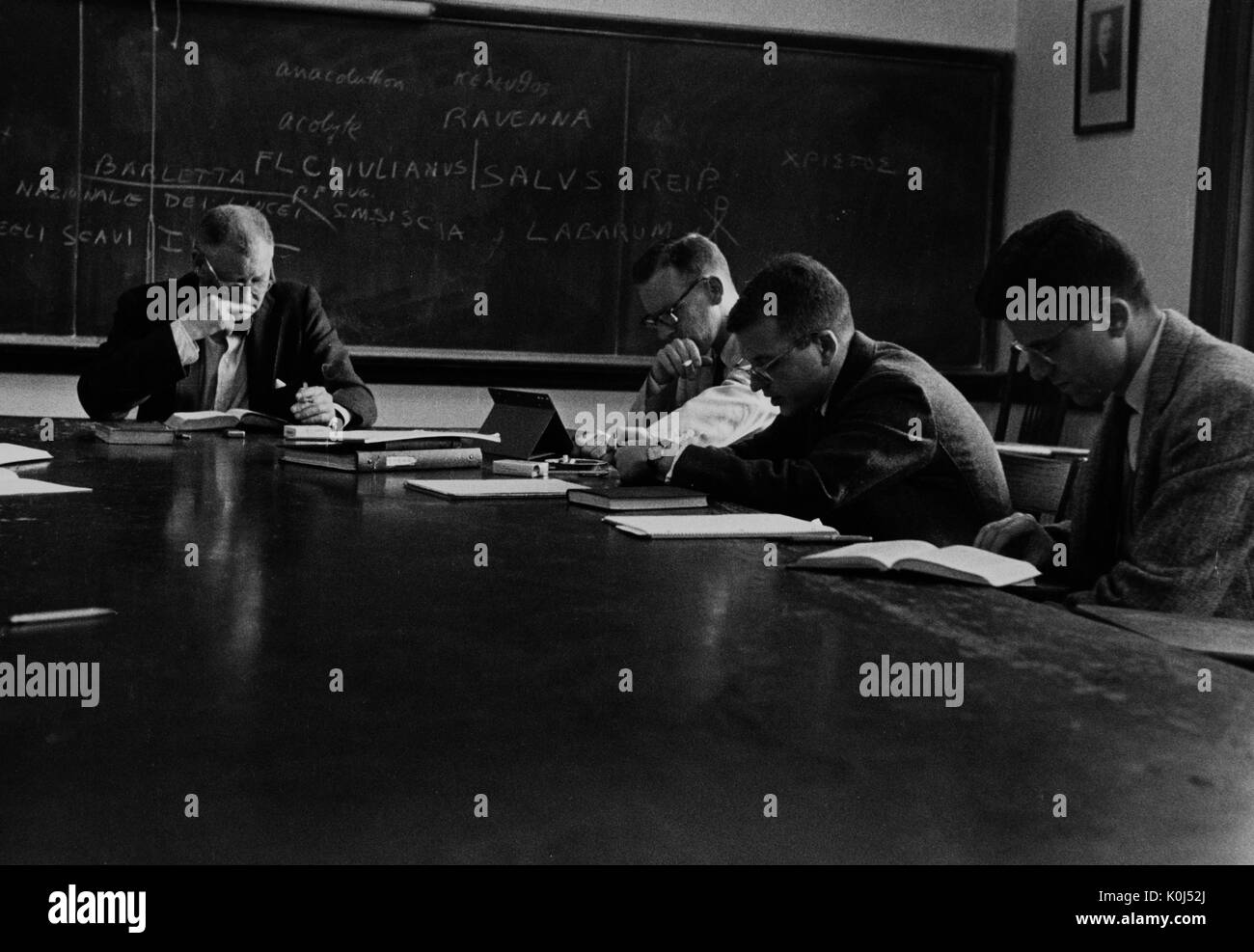 Candid photograph of classicist and archaeologist Henry Thompson Rowell (left) teaching a Latin class at the Johns Hopkins University. 1960. Stock Photo