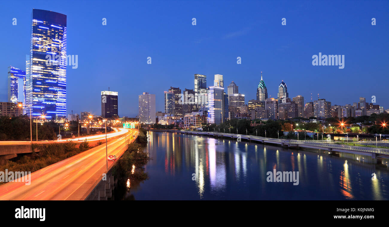 Philadelphia skyline illuminated and reflected into Schuylkill River at dusk, USA Stock Photo
