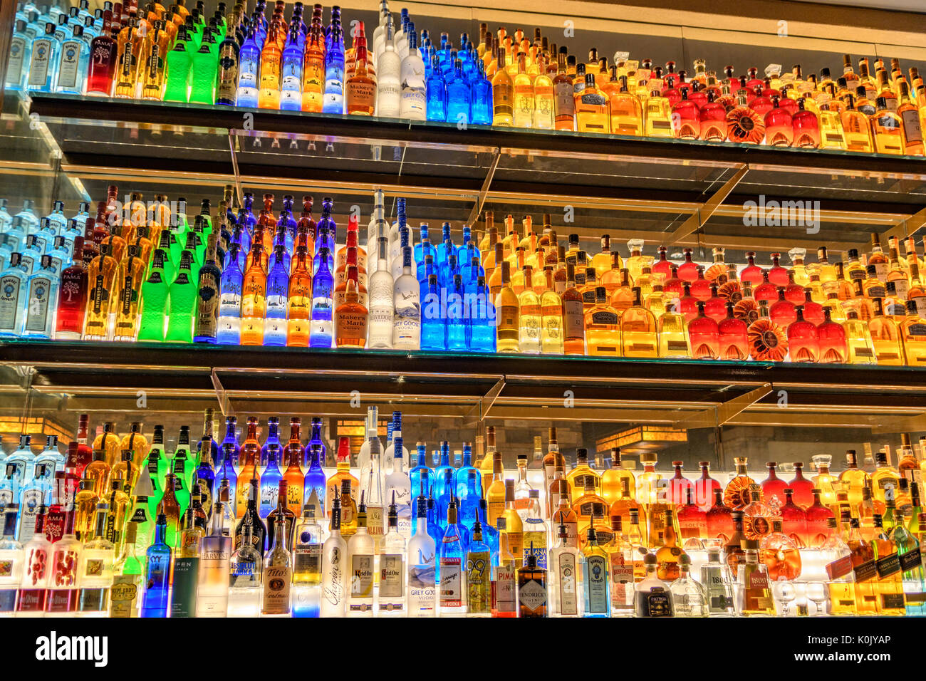 Firebird's Bar and Grill restaurant in Montgomery, Alabama lighted backbar shelving with hundreds of brightly colored liquor bottles on display. Stock Photo